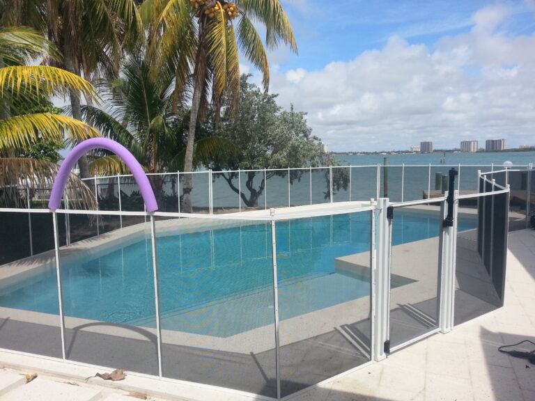 White removable mesh pool fence with a self-closing safety gate around a residential pool