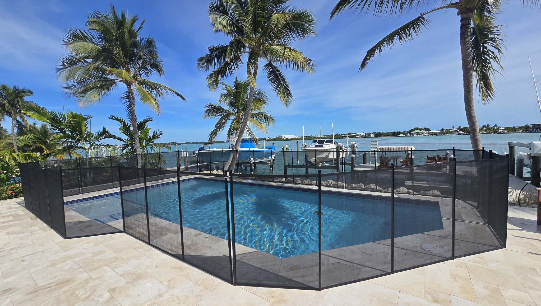 Black removable pool safety fence installed at a waterfront home in the Florida Keys